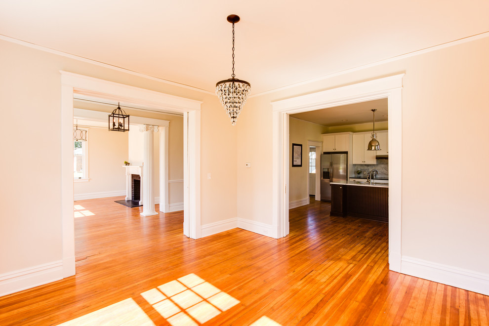 Design ideas for an expansive modern kitchen/dining combo in Richmond with beige walls and light hardwood floors.
