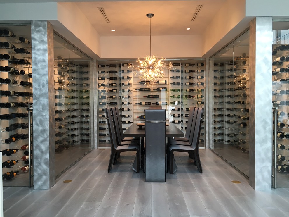 Large contemporary wine cellar in Miami with display racks and grey floor.