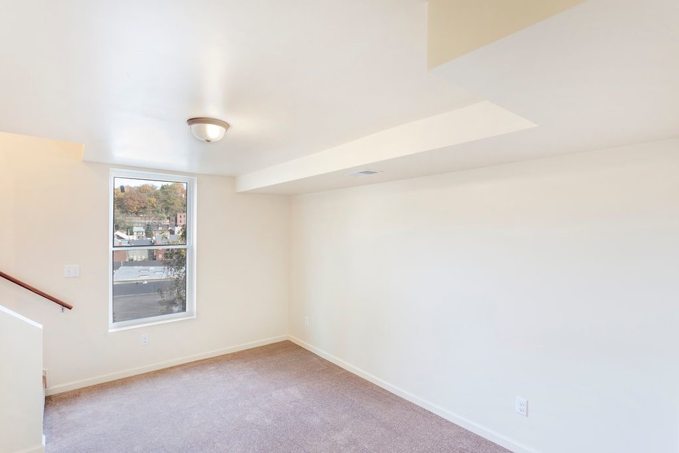 Example of a small transitional carpeted and beige floor home design design with white walls