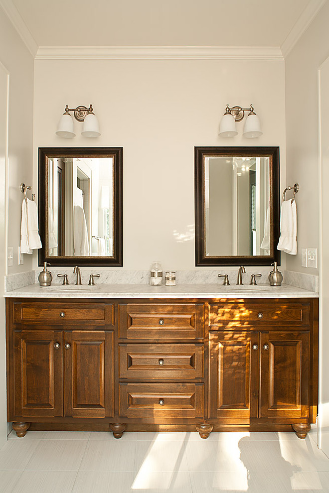 This is an example of a country bathroom in Atlanta with marble benchtops.
