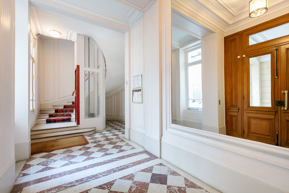 Design ideas for a large traditional foyer in Paris with white walls.