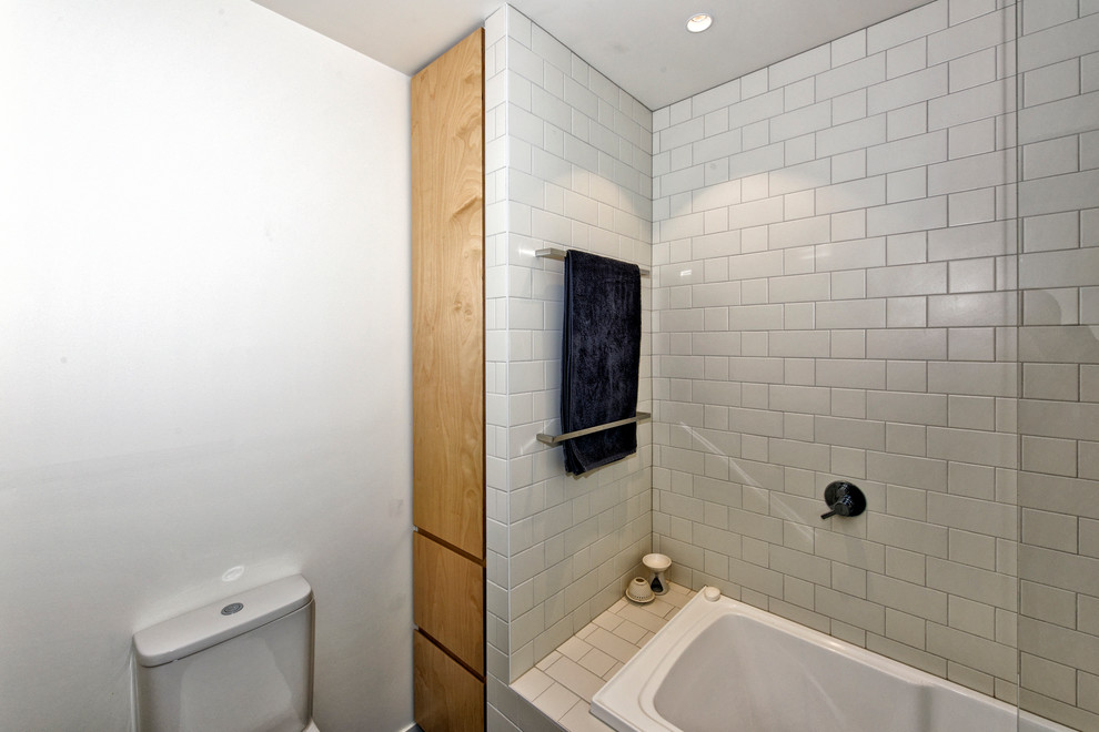 Small contemporary kids bathroom in Melbourne with light wood cabinets, a shower/bathtub combo, white tile, subway tile, an undermount sink, engineered quartz benchtops and a hinged shower door.