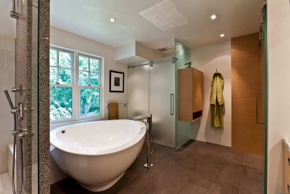 Design ideas for a large contemporary bathroom in Toronto with a vessel sink, flat-panel cabinets, light wood cabinets, engineered quartz benchtops, a freestanding tub, an open shower, a one-piece toilet, white walls and ceramic floors.