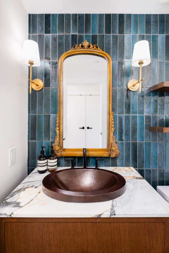 This is an example of a small classic cloakroom in Vancouver with shaker cabinets, brown cabinets, a two-piece toilet, blue tiles, porcelain tiles, blue walls, marble flooring, a built-in sink, marble worktops, black floors, white worktops and a built in vanity unit.