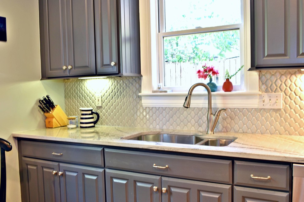 Small elegant medium tone wood floor and brown floor enclosed kitchen photo in Austin with an undermount sink, beaded inset cabinets, gray cabinets, quartzite countertops, gray backsplash, mosaic tile backsplash, stainless steel appliances and no island