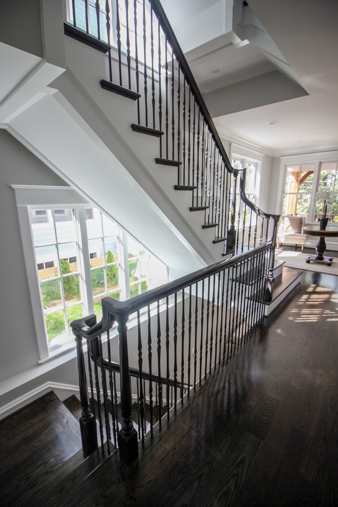 Inspiration for a large transitional wooden l-shaped mixed material railing staircase remodel in DC Metro with painted risers