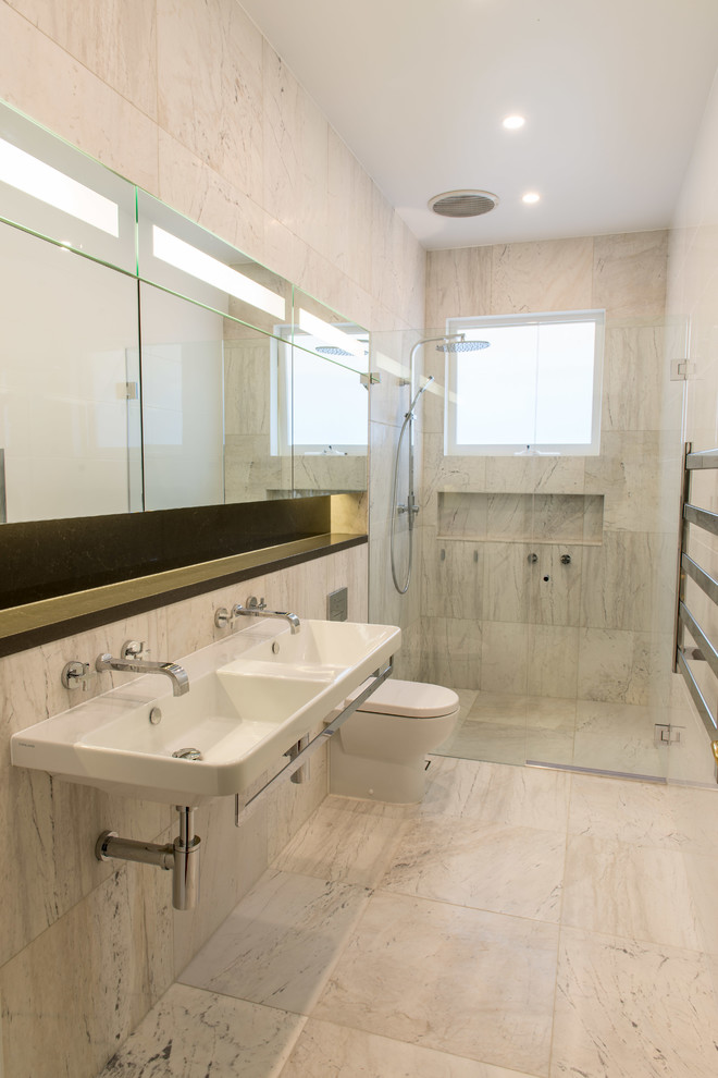 Design ideas for a contemporary master bathroom in Central Coast with engineered quartz benchtops, stone tile, an alcove shower, a one-piece toilet, beige tile, beige walls and a trough sink.