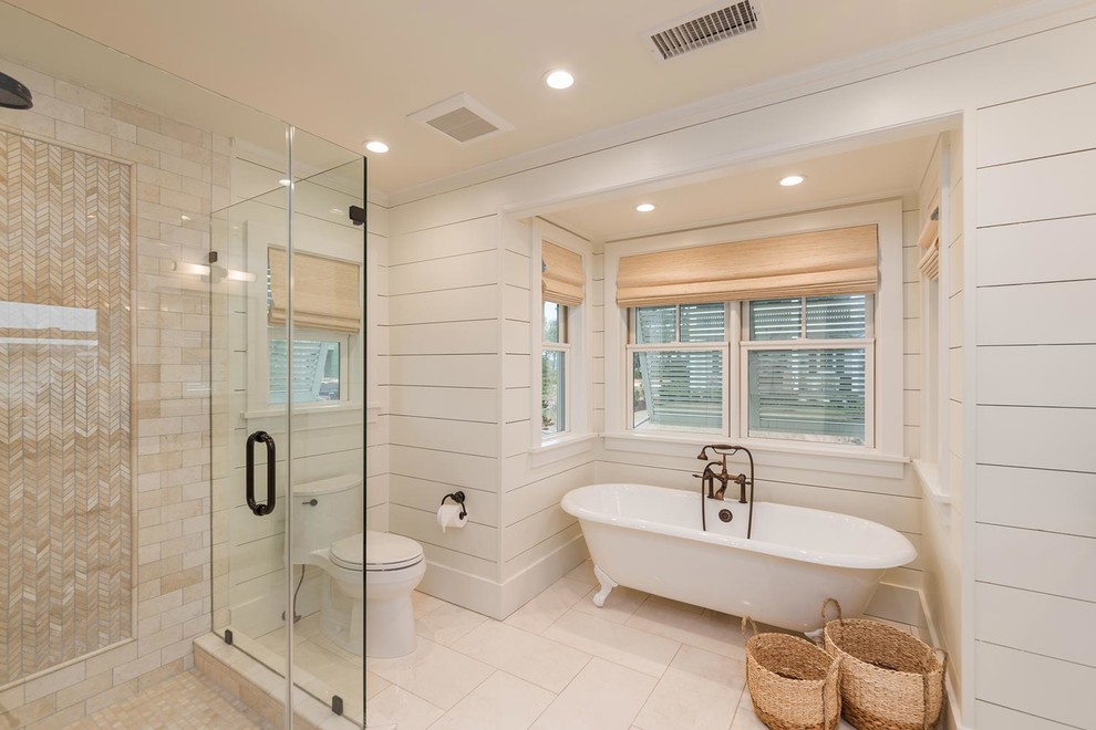 Inspiration for a mid-sized beach style master bathroom in Atlanta with a claw-foot tub, a corner shower, white walls, white floor, a hinged shower door, shaker cabinets, white cabinets, an undermount sink, solid surface benchtops and brown benchtops.