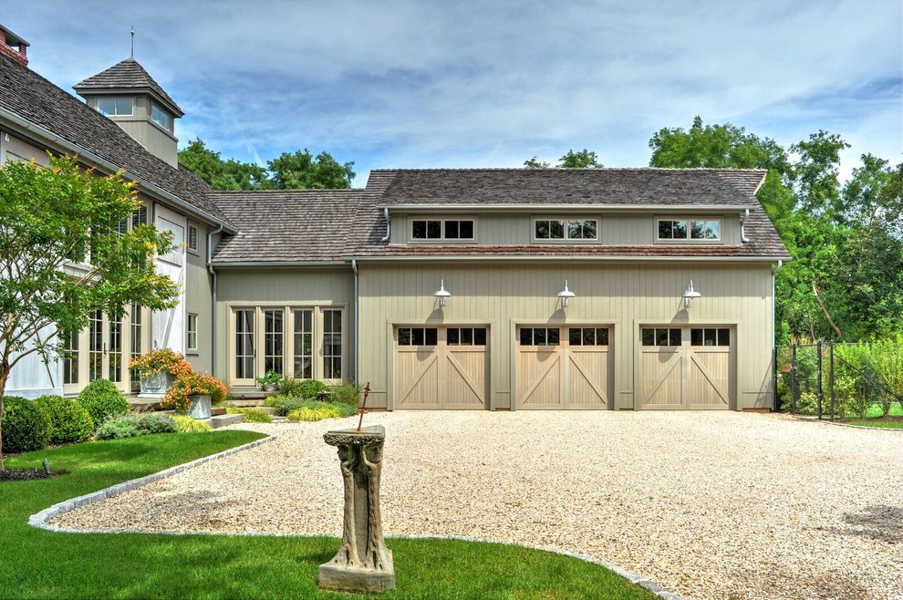 Inspiration for a large country attached three-car garage in Burlington.