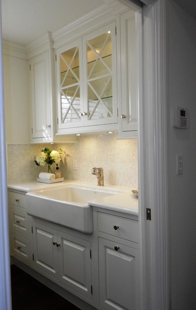 Inspiration for a mid-sized traditional laundry room in Miami with a farmhouse sink, raised-panel cabinets, white cabinets, quartzite benchtops, white walls, dark hardwood floors and a side-by-side washer and dryer.