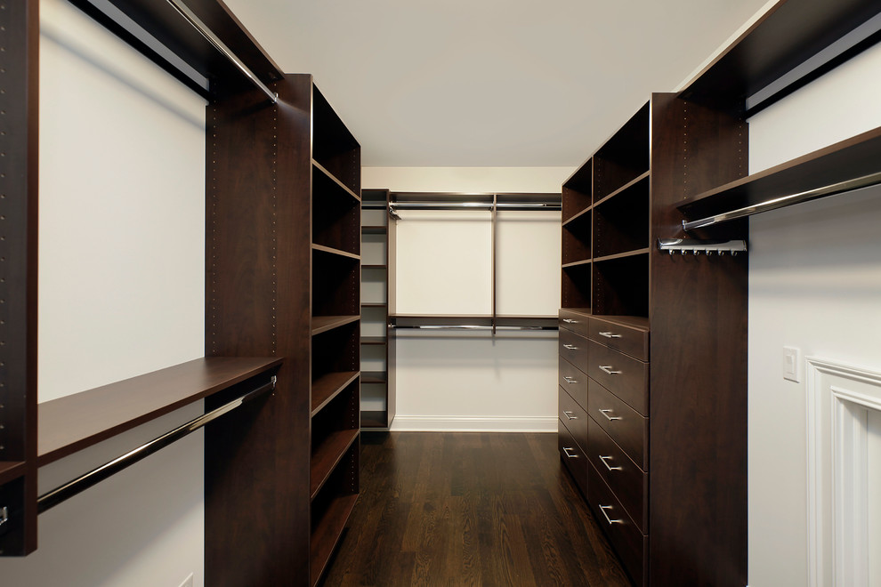 Inspiration for a large transitional gender-neutral walk-in wardrobe in Chicago with open cabinets, dark wood cabinets and dark hardwood floors.