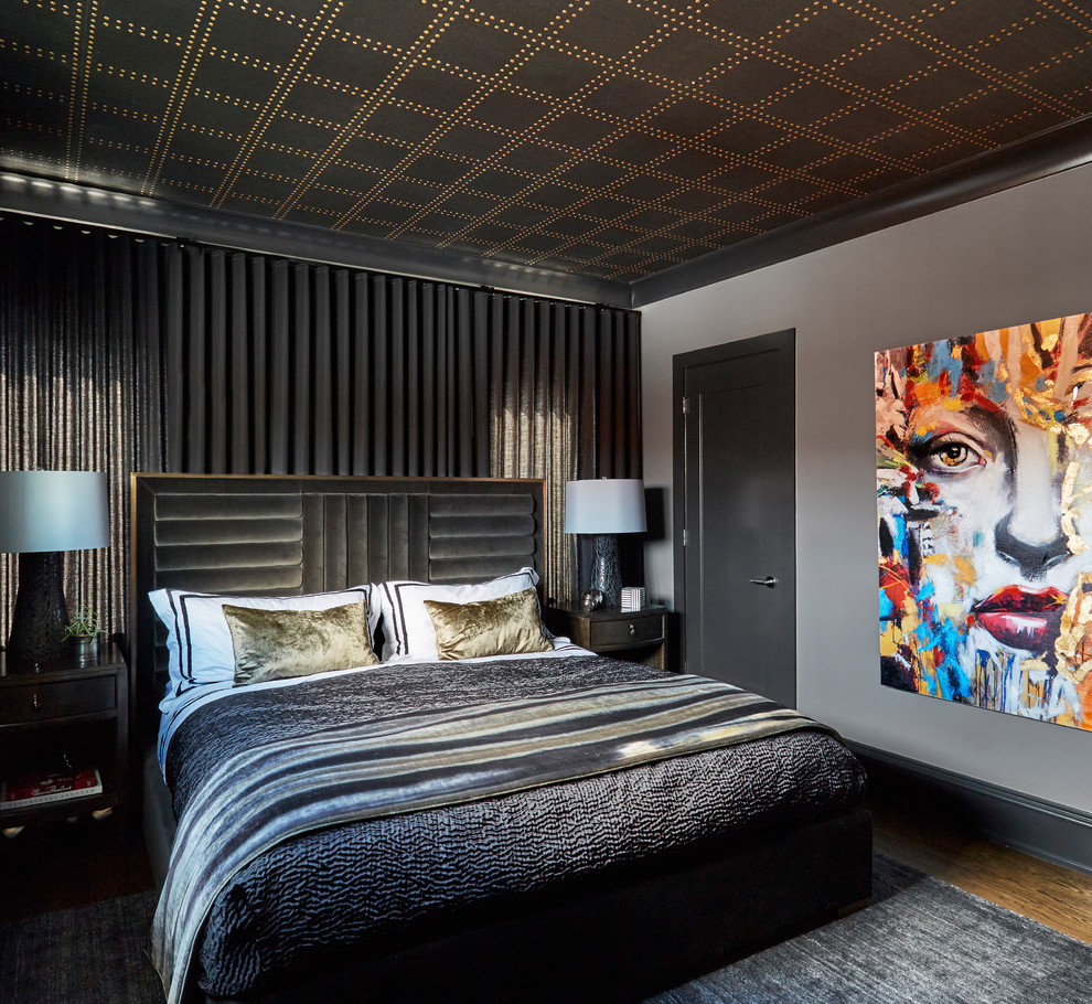 Photo of a contemporary bedroom in Chicago with black walls, medium hardwood floors and brown floor.