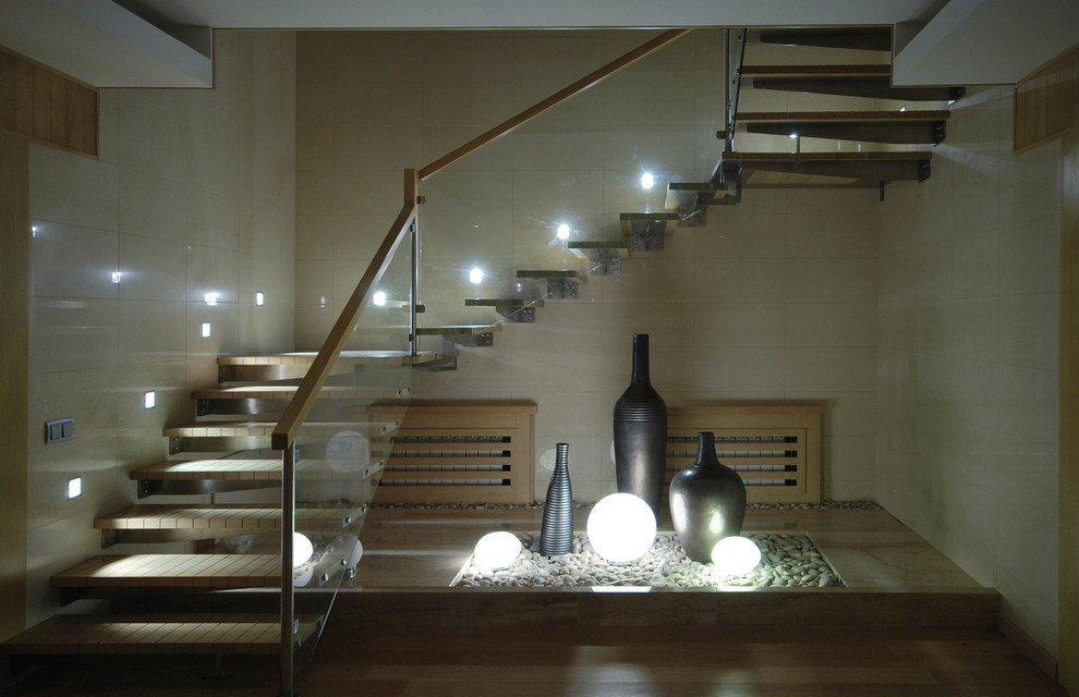 Inspiration for a mid-sized contemporary wood u-shaped staircase in Moscow with open risers.
