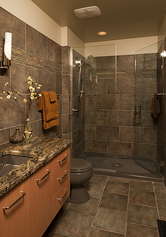 Inspiration for a small asian 3/4 bathroom in Chicago with flat-panel cabinets, medium wood cabinets, a one-piece toilet, gray tile, ceramic tile, grey walls, ceramic floors, an undermount sink and engineered quartz benchtops.