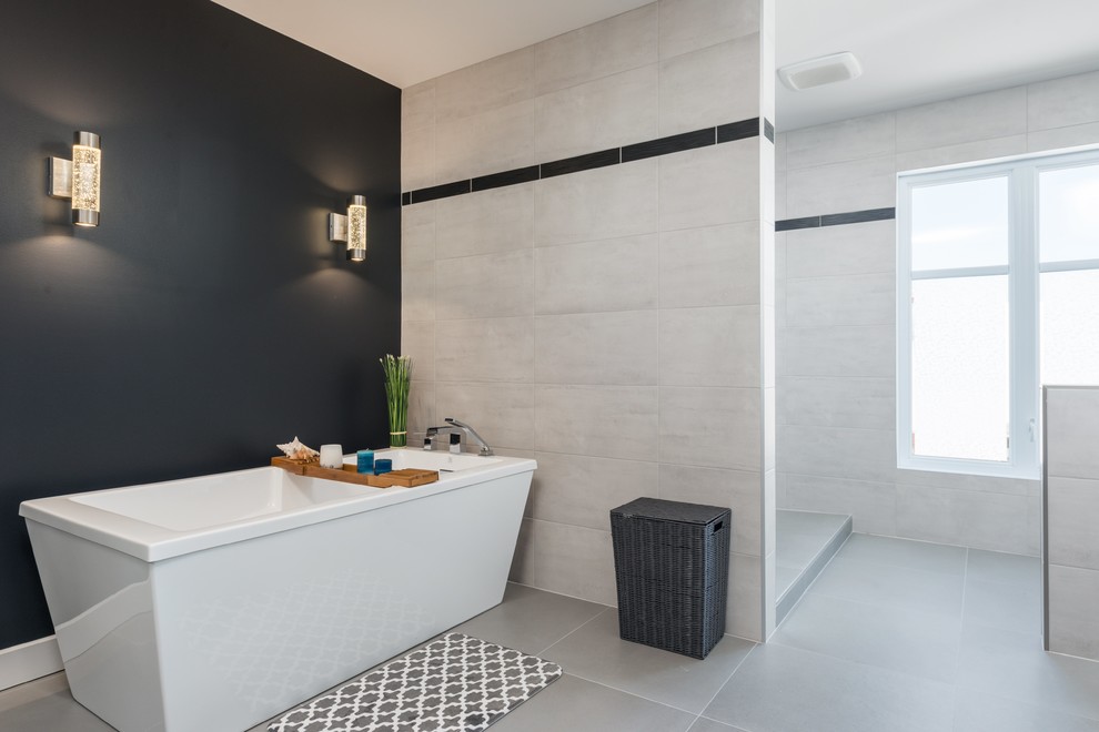 Photo of an expansive modern master bathroom in Montreal with a freestanding tub, an open shower, ceramic tile, black walls, porcelain floors and an open shower.