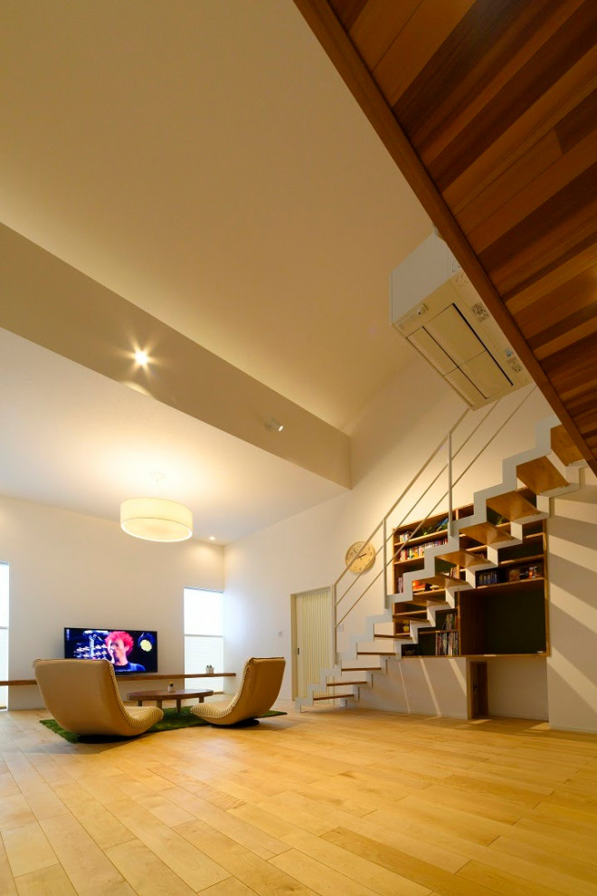 This is an example of a mid-sized asian wood straight staircase in Tokyo with open risers and metal railing.