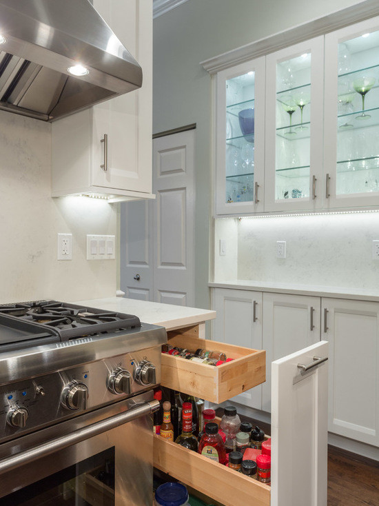 Eat-in kitchen - large transitional l-shaped dark wood floor eat-in kitchen idea in Chicago with a farmhouse sink, shaker cabinets, white cabinets, marble countertops, white backsplash, subway tile backsplash, stainless steel appliances and an island