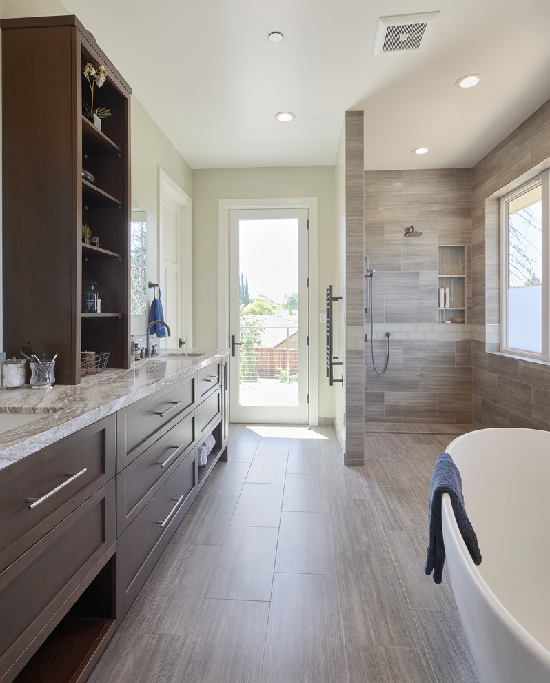 Large contemporary master bathroom in San Francisco with flat-panel cabinets, dark wood cabinets, a freestanding tub, an open shower, gray tile, glass tile, green walls, medium hardwood floors, an undermount sink, granite benchtops, brown floor, an open shower and grey benchtops.