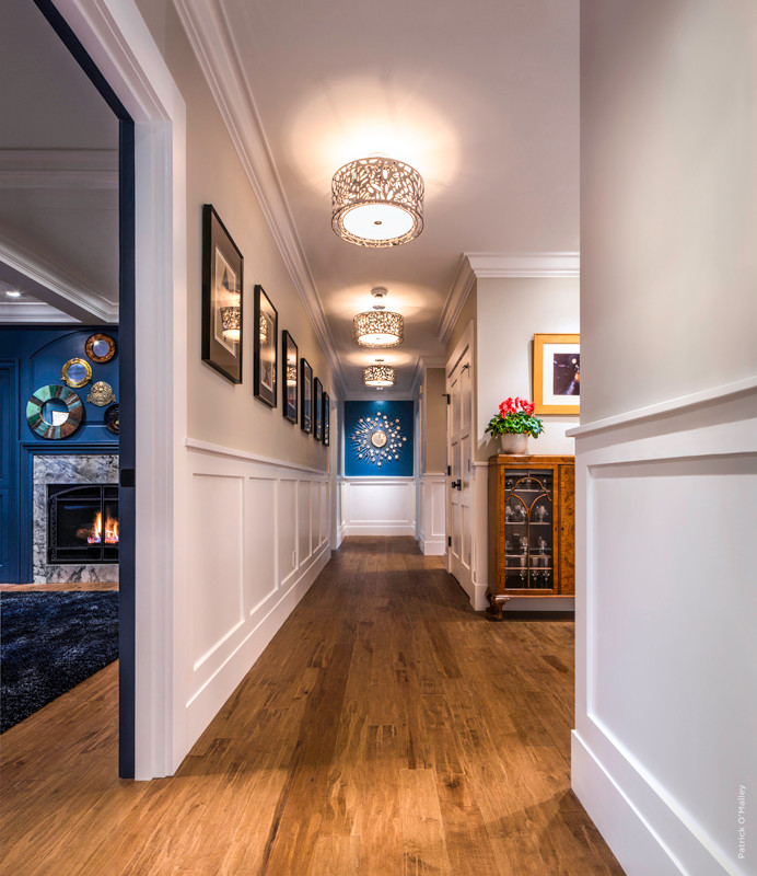 Photo of a large transitional hallway in Boston with beige walls and medium hardwood floors.