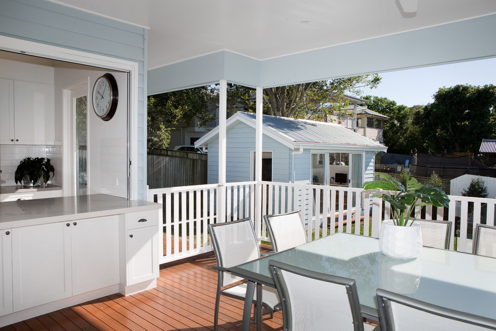 Photo of a large contemporary backyard deck in Brisbane with a roof extension.