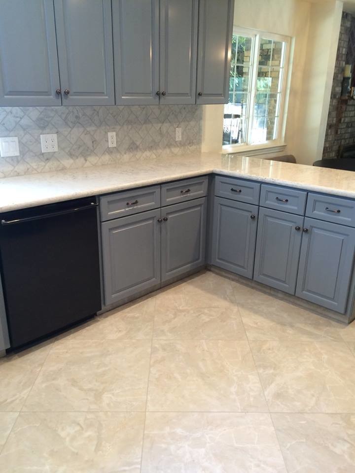 Inspiration for a large traditional eat-in kitchen in Sacramento with grey cabinets, marble benchtops, grey splashback, marble splashback, black appliances and porcelain floors.