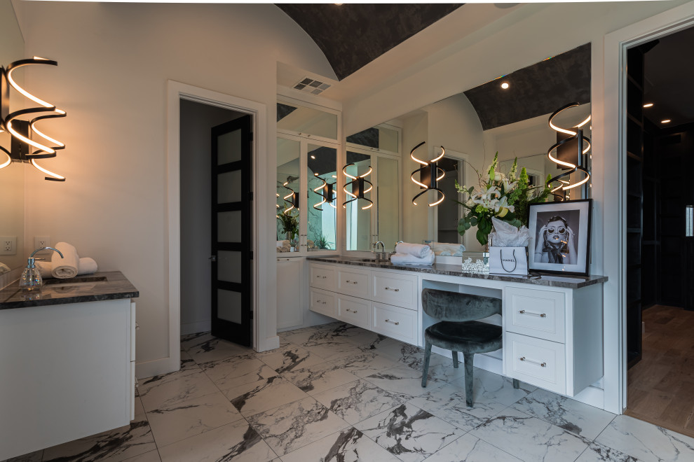 Design ideas for a large modern master bathroom in Oklahoma City with white cabinets, a freestanding tub, a double shower, black and white tile, porcelain tile, white walls, porcelain floors, an undermount sink, marble benchtops, white floor, a hinged shower door, black benchtops, a double vanity, a floating vanity and vaulted.