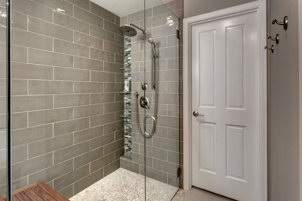 Example of a large transitional master multicolored tile and matchstick tile pebble tile floor freestanding bathtub design in Seattle with shaker cabinets, dark wood cabinets, a two-piece toilet, beige walls, an undermount sink and quartz countertops