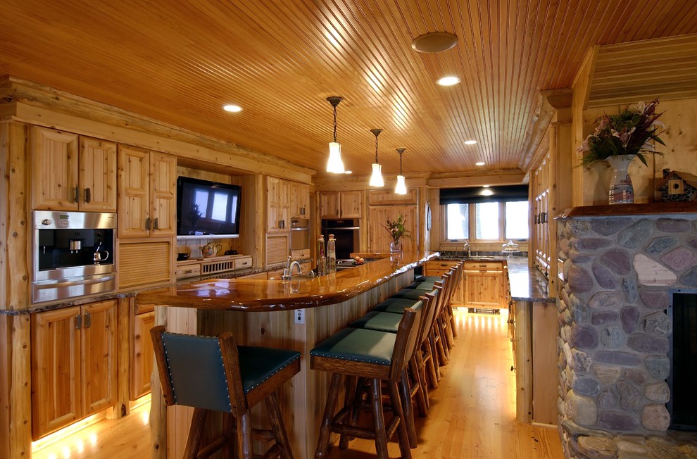 Photo of a traditional kitchen in Minneapolis with recessed-panel cabinets, medium wood cabinets and panelled appliances.