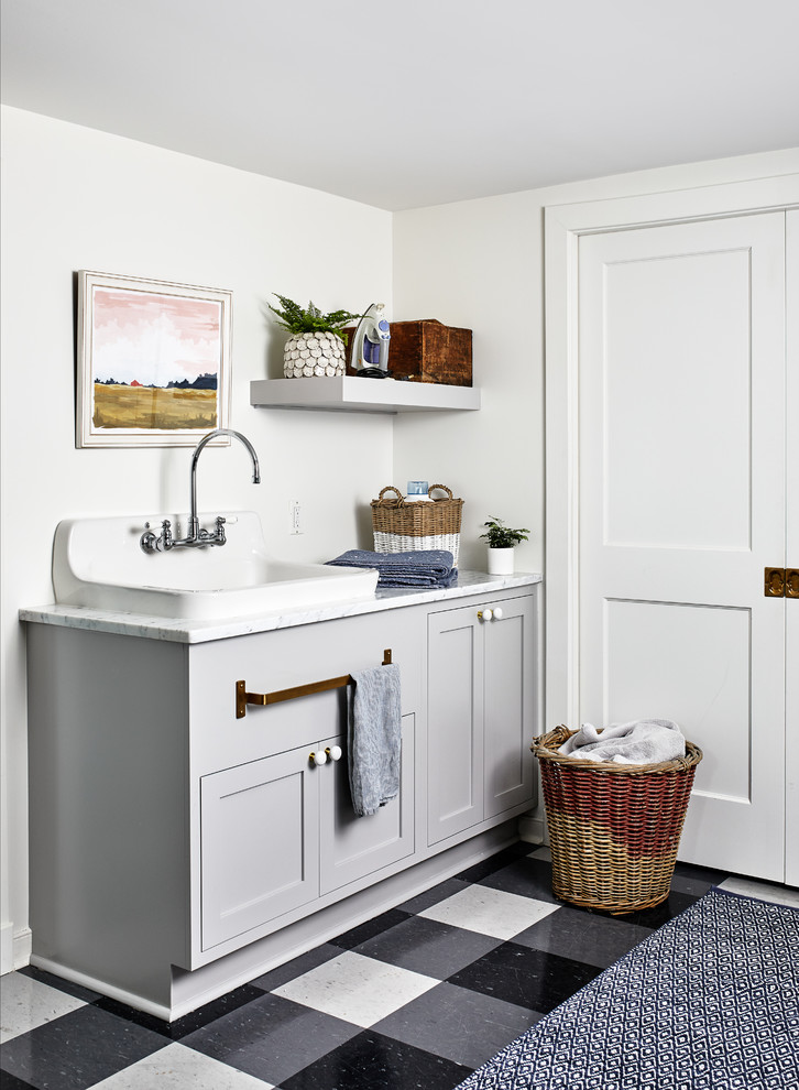 Design ideas for a beach style laundry room in DC Metro with shaker cabinets, grey cabinets, white walls, multi-coloured floor and white benchtop.