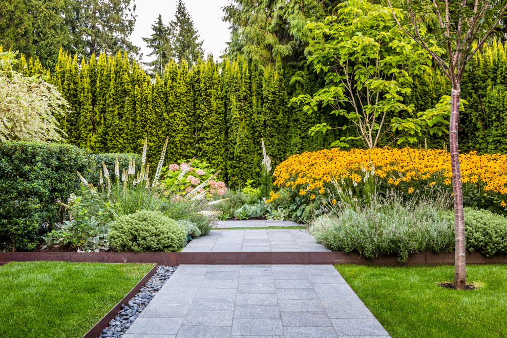 Photo of an asian partial sun garden in Vancouver with concrete pavers.