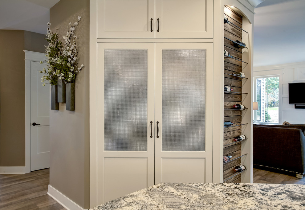 Transitional open concept kitchen photo in Grand Rapids with white cabinets, granite countertops and an island