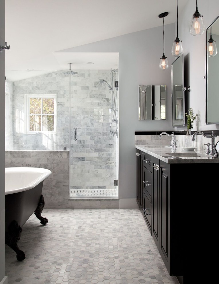 Photo of a traditional master bathroom in DC Metro with raised-panel cabinets, black cabinets, a claw-foot tub, an alcove shower, gray tile, grey walls, mosaic tile floors, an undermount sink, grey floor and a hinged shower door.