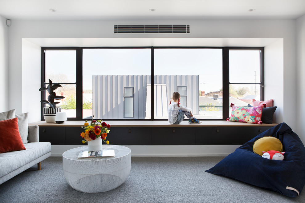 Inspiration for a modern living room in Melbourne with white walls and carpet.
