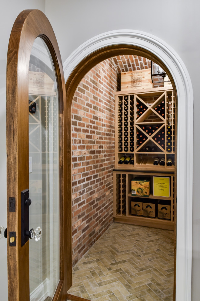 Design ideas for a large traditional wine cellar in Chicago with brick floors and brown floor.