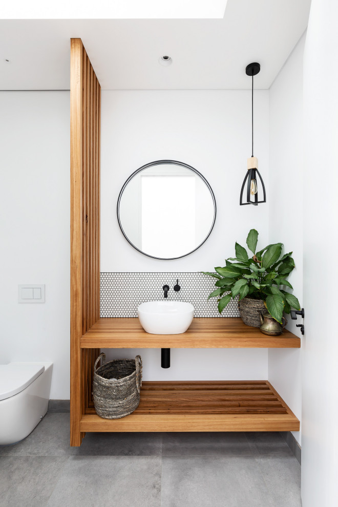 Idée de décoration pour une salle de bain design avec un carrelage blanc, mosaïque, un mur blanc, un plan de toilette en bois, un sol gris, un plan de toilette marron et meuble simple vasque.