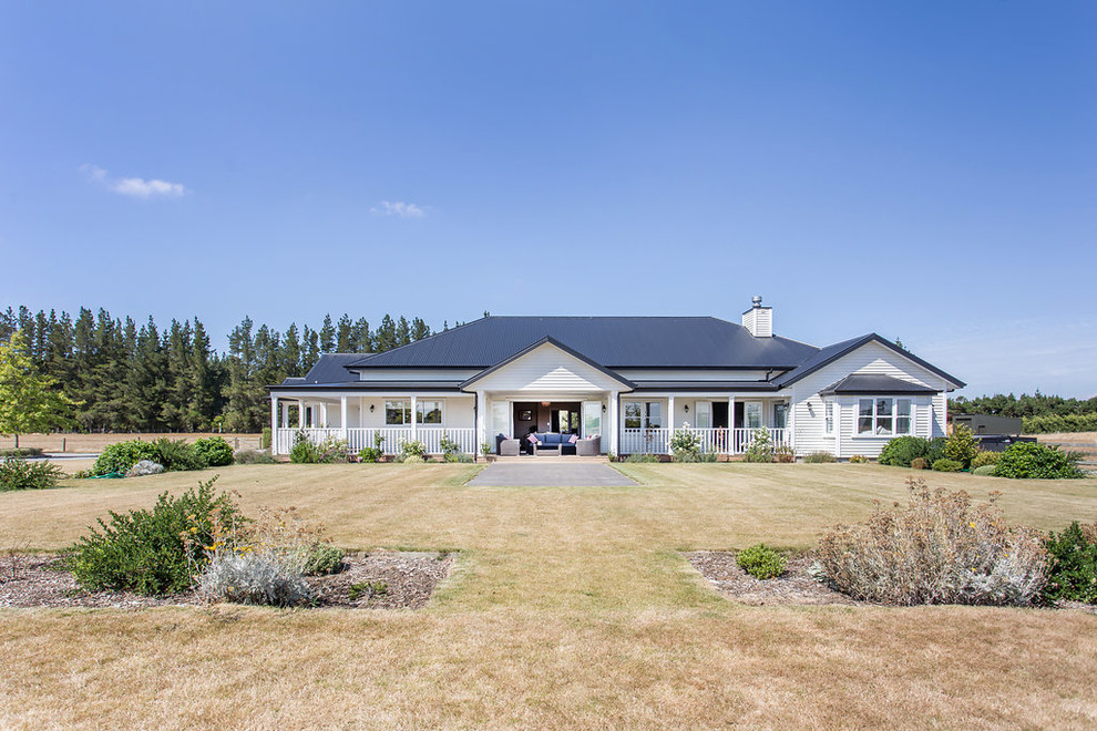 Inspiration for an Expansive country One-storey White house exterior in Christchurch With Mixed Siding and a Hip Roof.