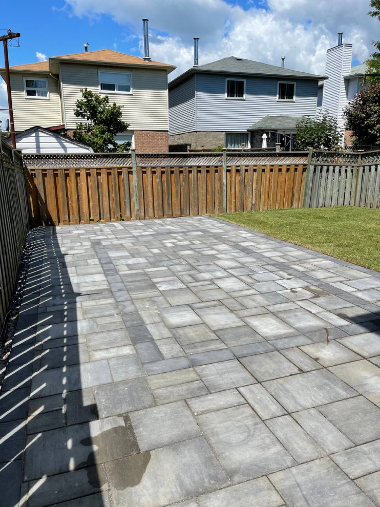 Design ideas for a medium sized modern back patio in Toronto with concrete slabs.