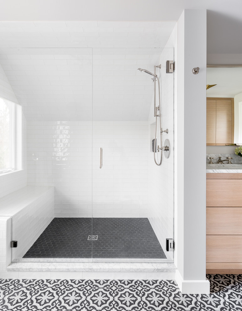Design ideas for a large transitional master bathroom in Seattle with flat-panel cabinets, light wood cabinets, an alcove shower, a wall-mount toilet, white tile, subway tile, grey walls, cement tiles, an undermount sink, marble benchtops, black floor and a hinged shower door.