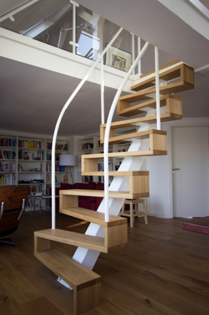 Inspiration for a mid-sized contemporary wood curved staircase in Other with wood risers.