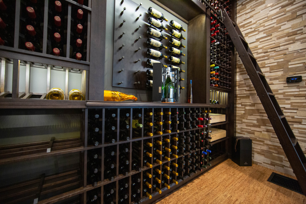 Inspiration for a large transitional cork floor and brown floor wine cellar remodel in Indianapolis with storage racks