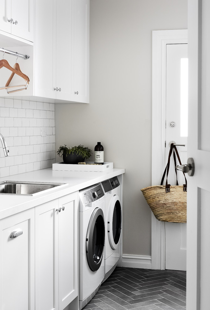 Transitional laundry room in Sydney with a drop-in sink, shaker cabinets, white cabinets, quartz benchtops, porcelain floors, a side-by-side washer and dryer, grey floor and white benchtop.