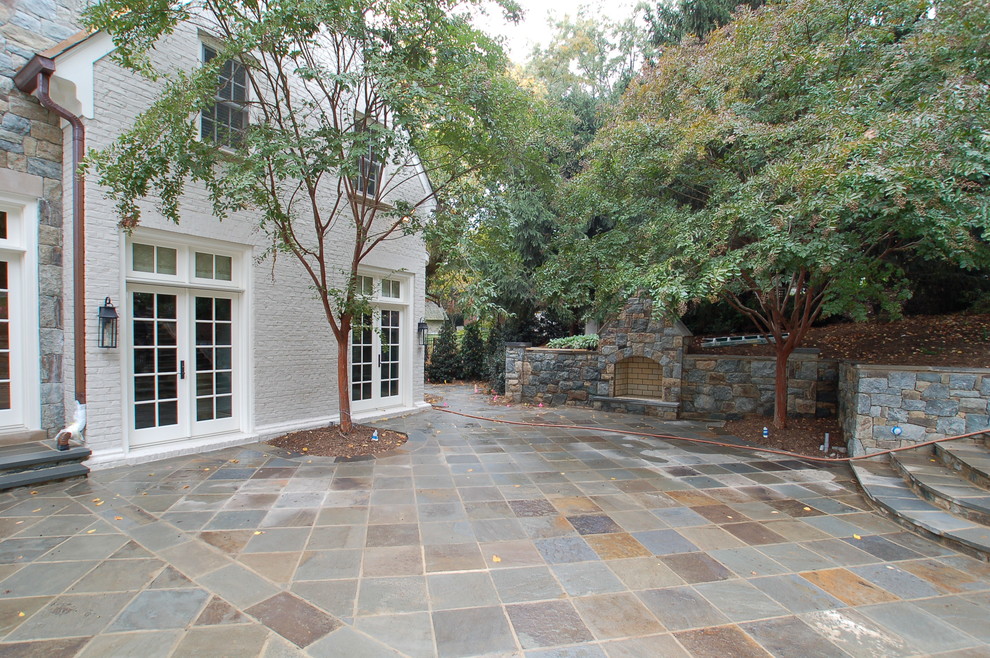 Example of a large transitional courtyard tile patio design in DC Metro with a fire pit and no cover