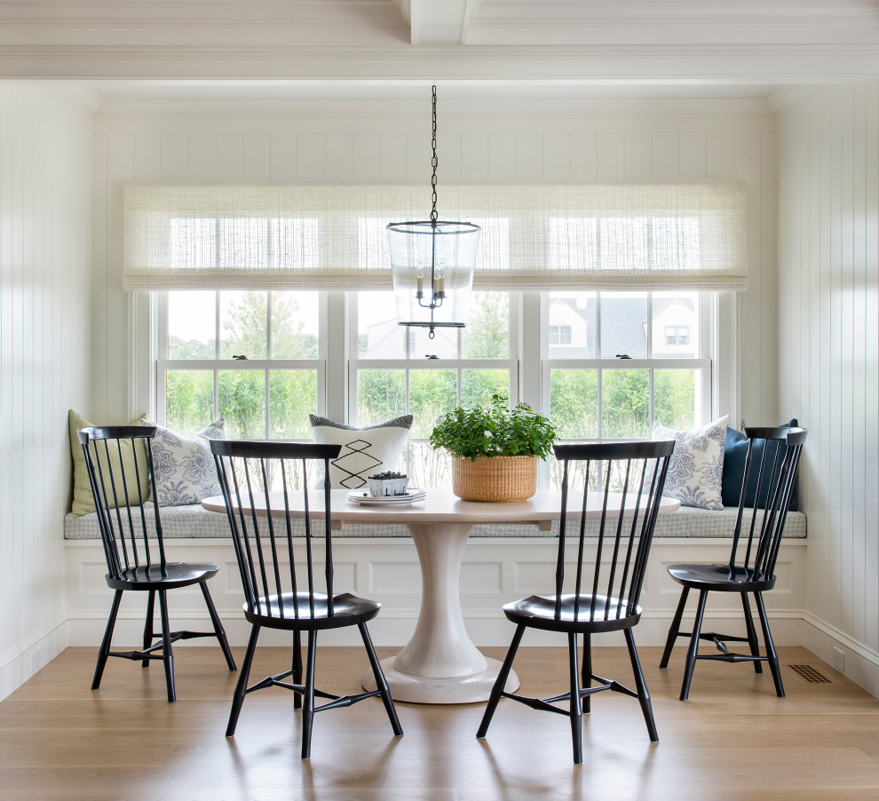 Beach style dining room in Providence with white walls, medium hardwood floors, brown floor and planked wall panelling.