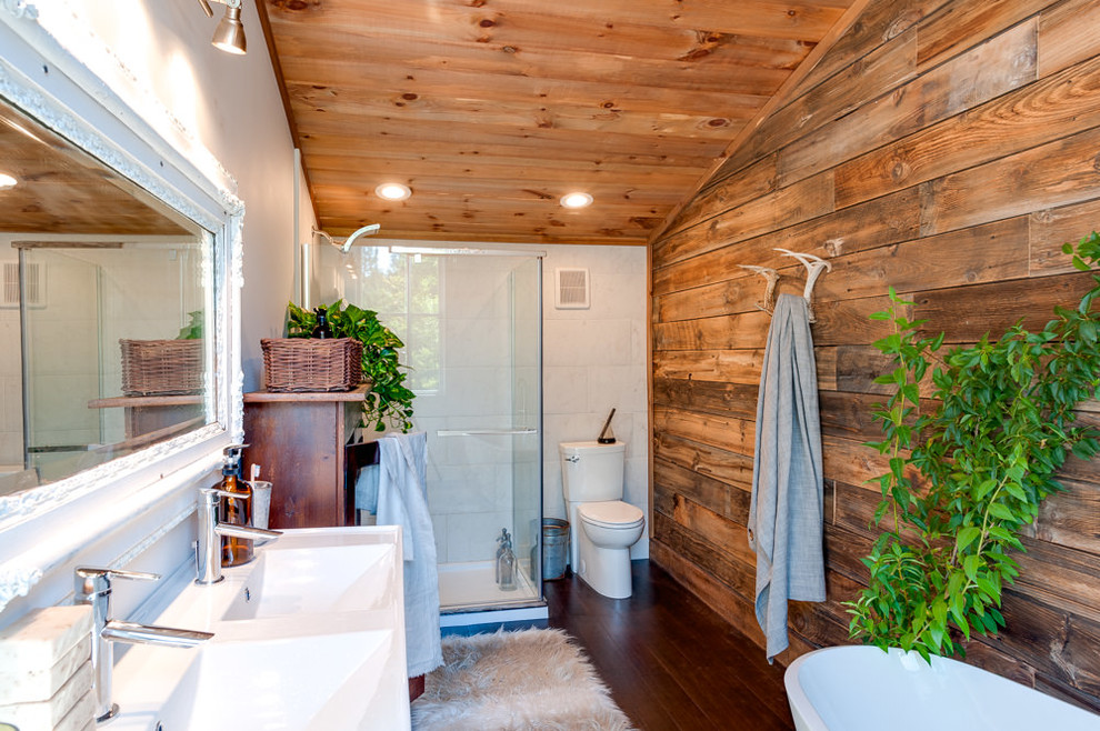 Photo of a country kids bathroom in Burlington with open cabinets, dark wood cabinets, a freestanding tub, an open shower, a one-piece toilet, white tile, ceramic tile, brown walls, bamboo floors, a vessel sink, wood benchtops, brown floor and brown benchtops.