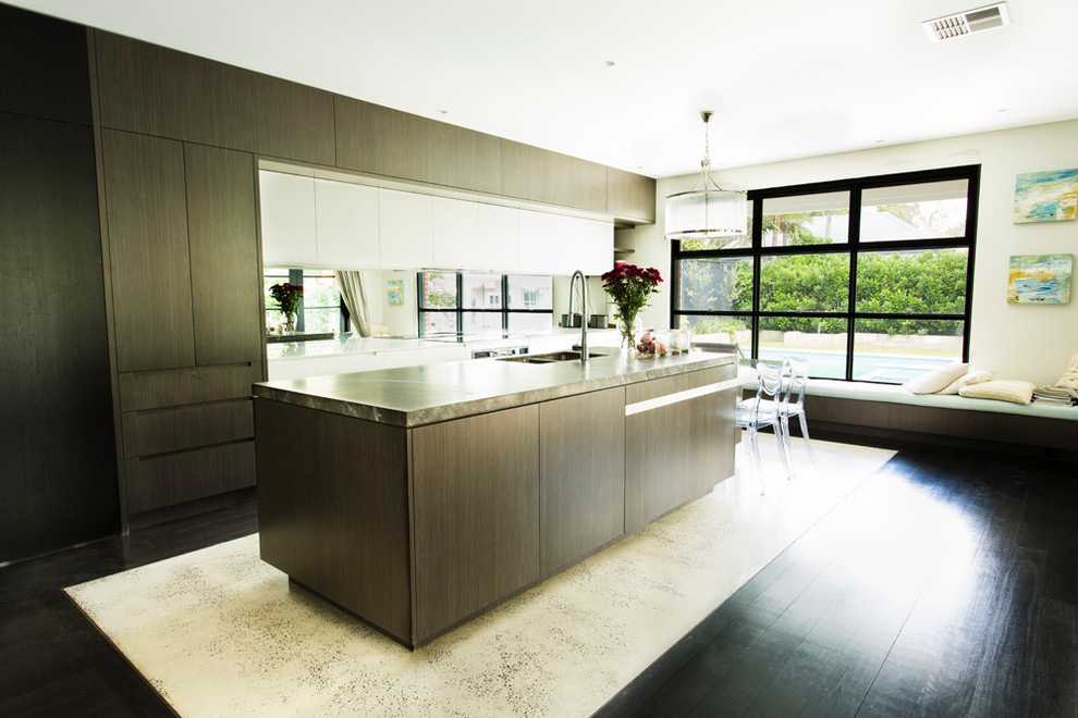 Contemporary kitchen in Sydney with a double-bowl sink, dark wood cabinets, marble benchtops, glass sheet splashback, stainless steel appliances, concrete floors and with island.