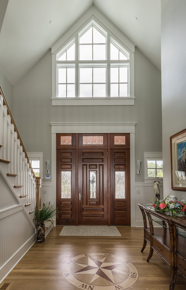 Beach style medium tone wood floor and brown floor foyer photo in Baltimore with gray walls and a dark wood front door
