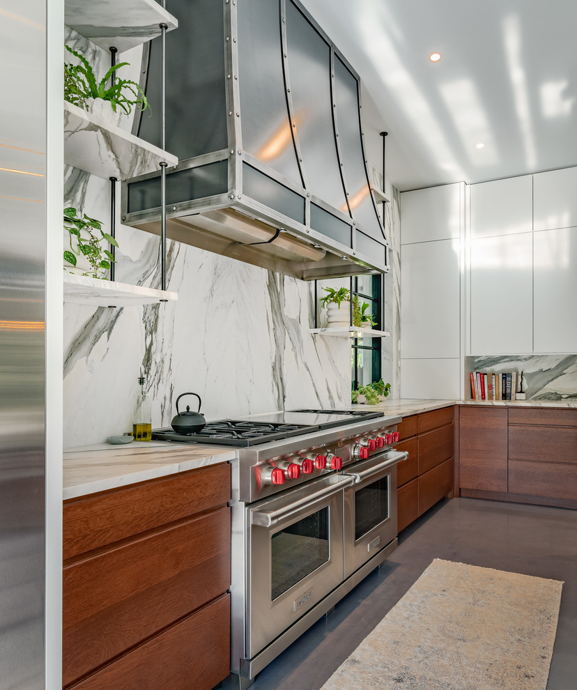 Kitchen pantry - concrete floor and gray floor kitchen pantry idea with an undermount sink, flat-panel cabinets, white cabinets, marble countertops, gray backsplash, marble backsplash, stainless steel appliances, an island and gray countertops