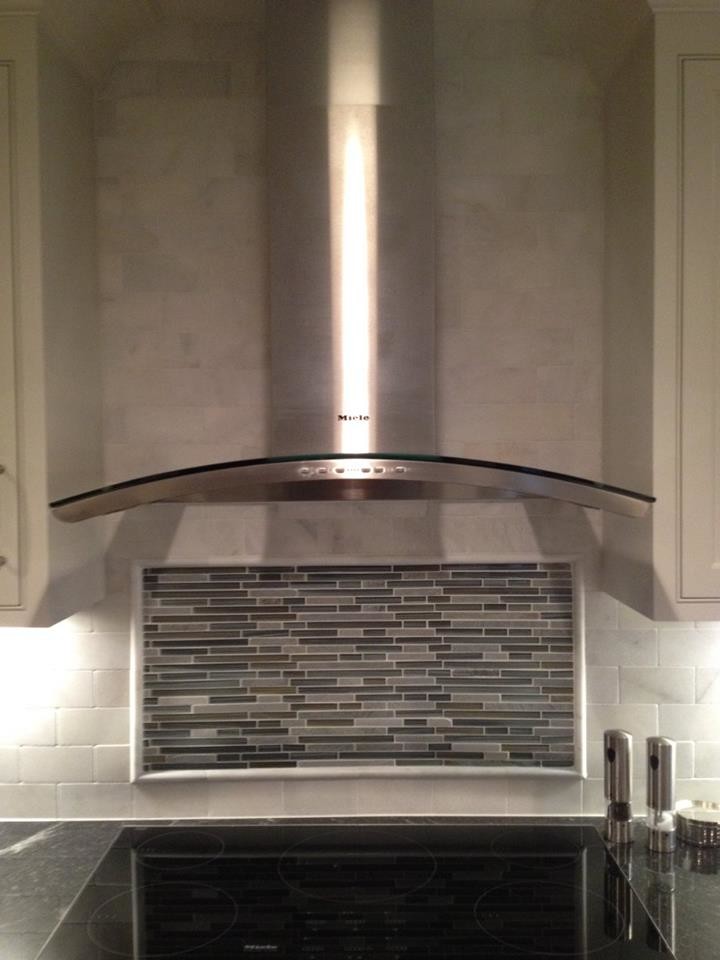 Large transitional l-shaped medium tone wood floor kitchen photo with beaded inset cabinets, white cabinets, white backsplash, subway tile backsplash, stainless steel appliances, a farmhouse sink and an island
