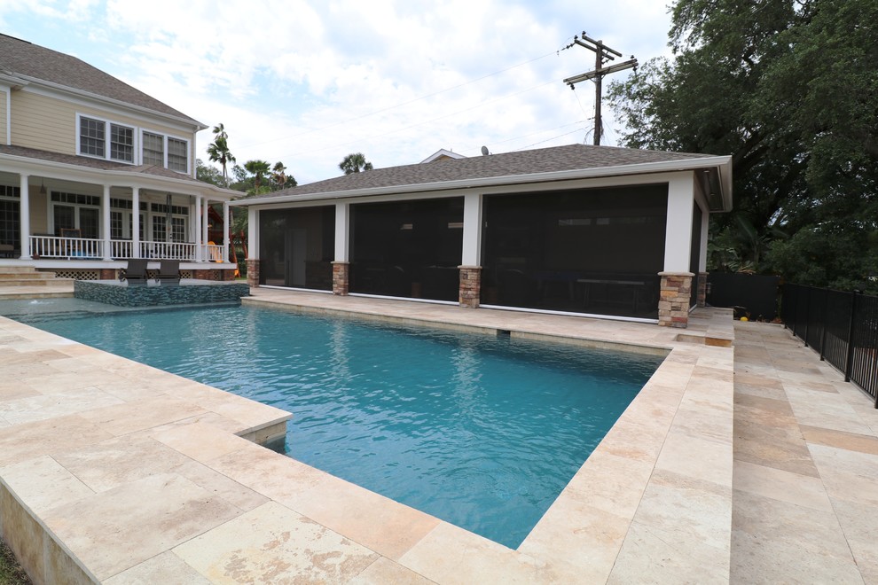 This is an example of a mid-sized contemporary backyard rectangular pool in Tampa with a hot tub and tile.