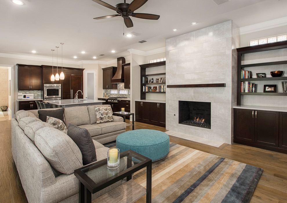 Example of a mid-sized transitional l-shaped medium tone wood floor and brown floor open concept kitchen design in DC Metro with an undermount sink, recessed-panel cabinets, dark wood cabinets, granite countertops, beige backsplash, ceramic backsplash, stainless steel appliances, an island and beige countertops